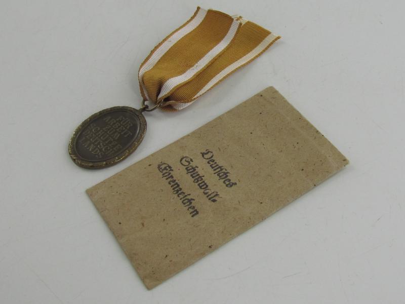 Westwall Medal with Paper Bag